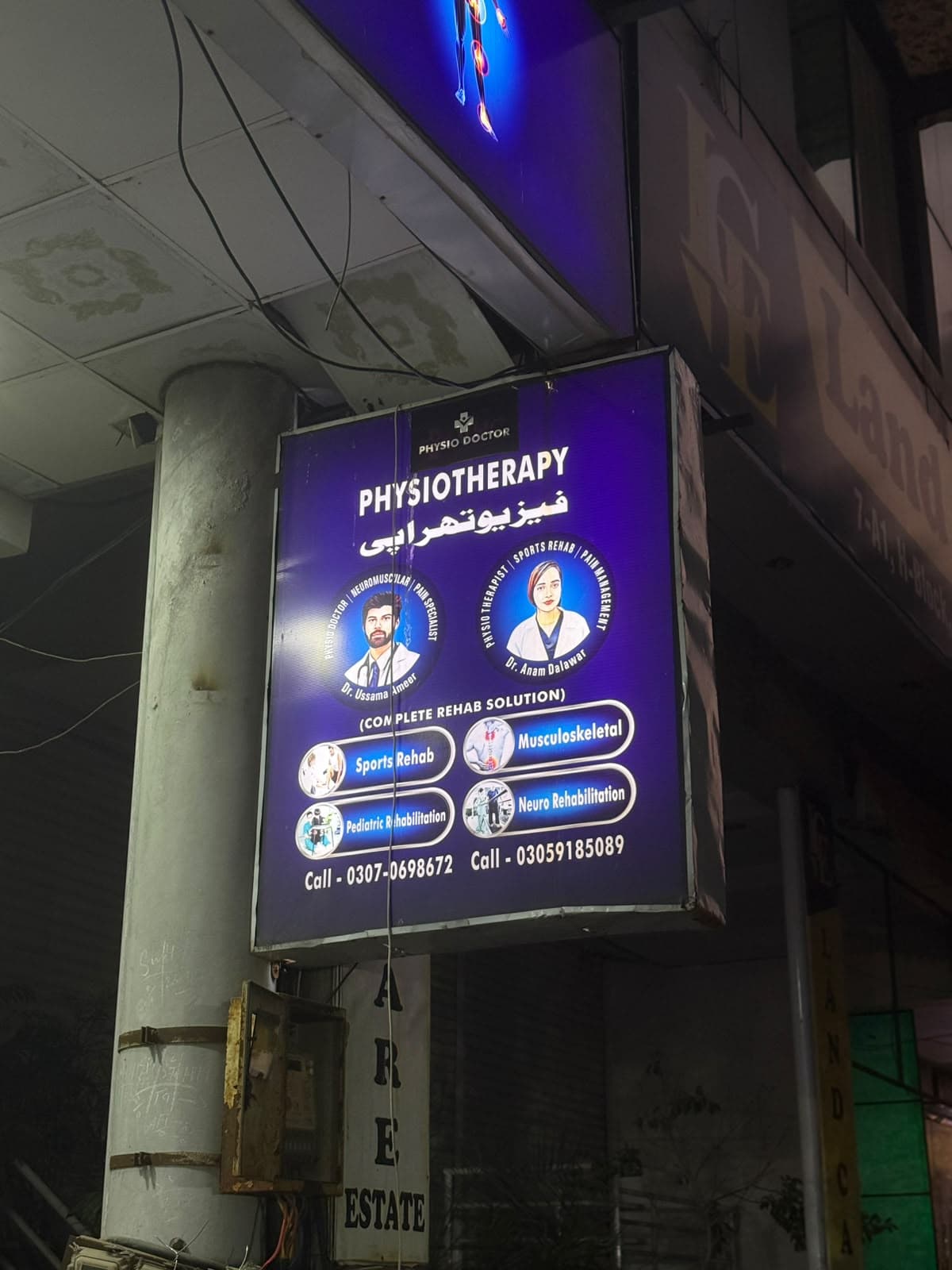 Clinic sign showing Physio Doctor services and consulting doctors