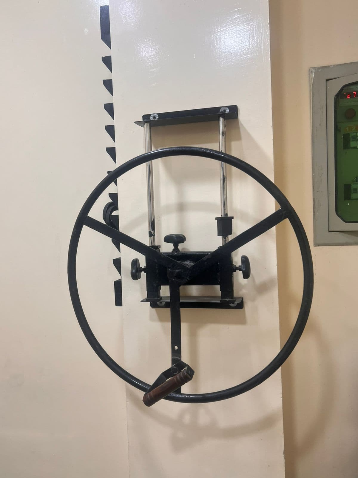 Wall-mounted shoulder wheel used for guided mobility exercises