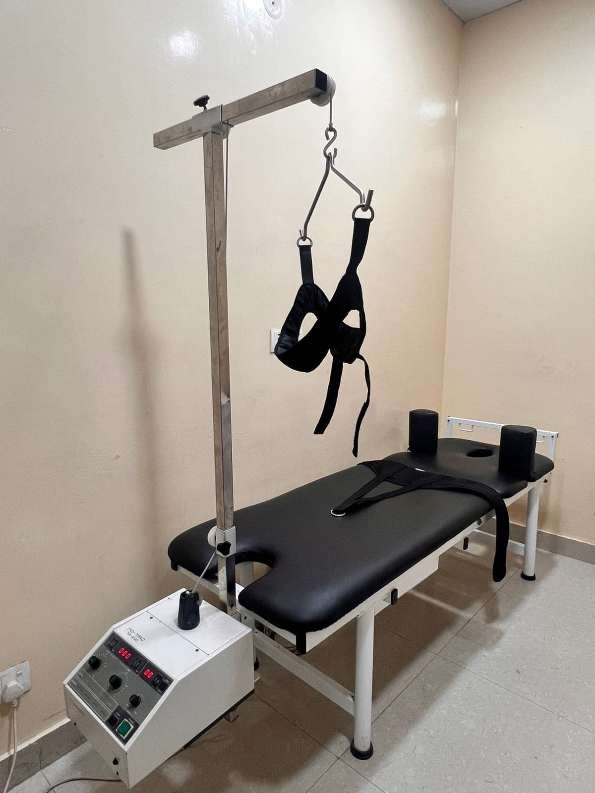 Mechanical traction unit with treatment table and cervical harness in the clinic