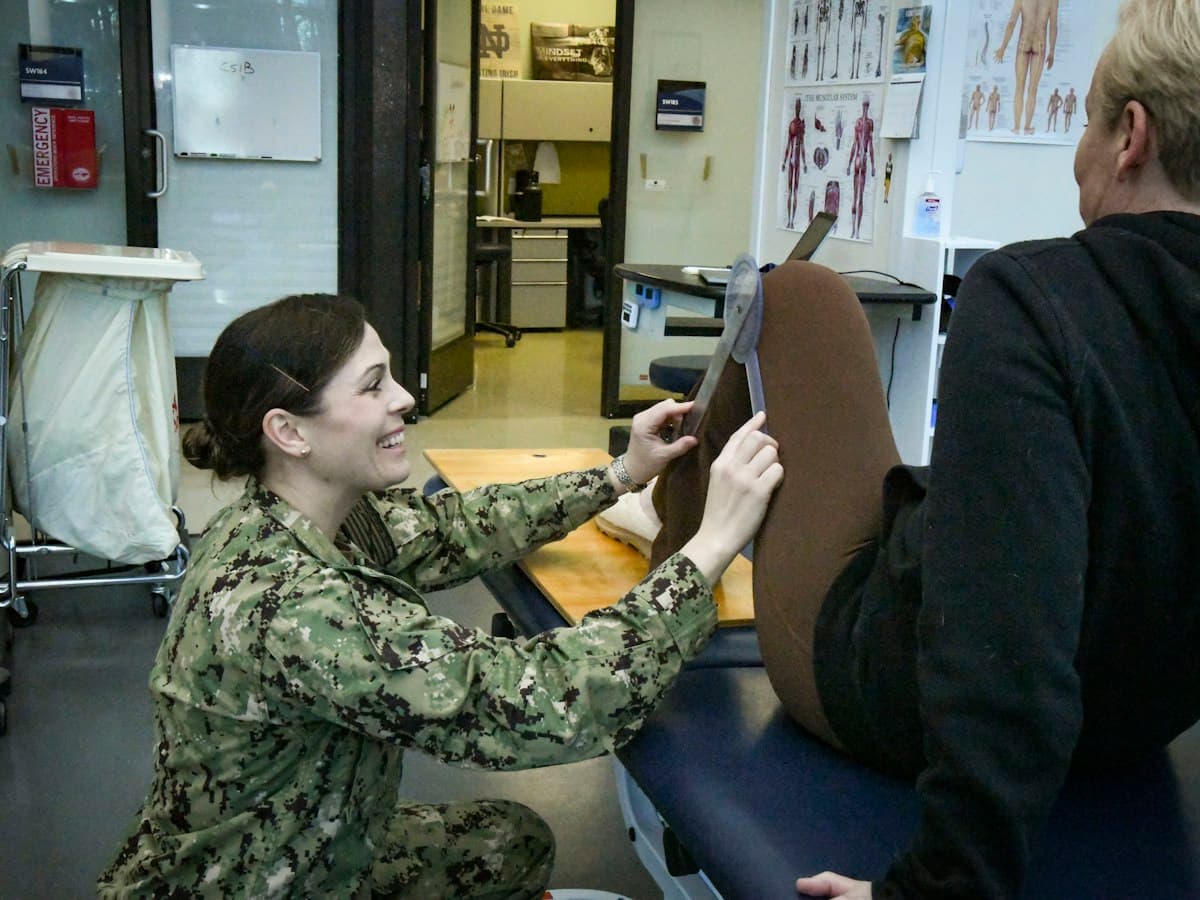 Physiotherapist measuring and assessing a patient's leg and hip range of motion